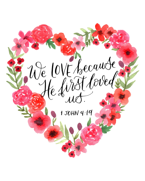 1 John 4:19 "We love because he first loved us" In black cursive surrounded by a heart shaped bouquet of red flowers