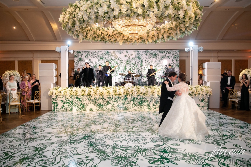 Wedding with green floral pattern on the dance floor and back wall