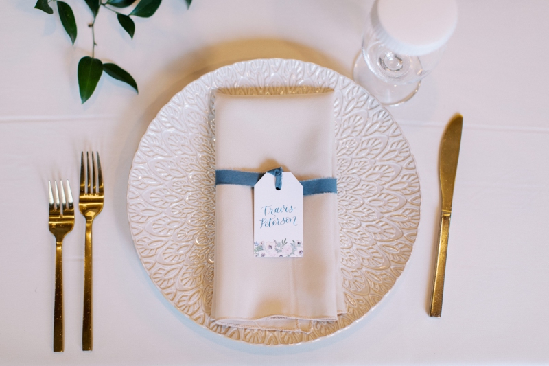 table setting with custom labeled paper attached to napkin
