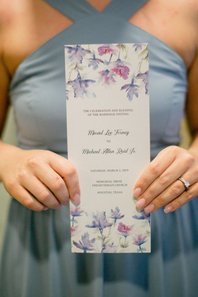 woman holding wedding invitation