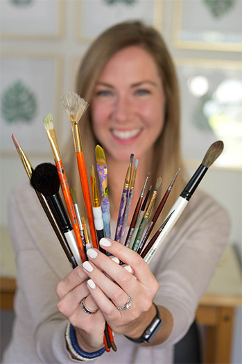 Bethany Saur holding paint brushes